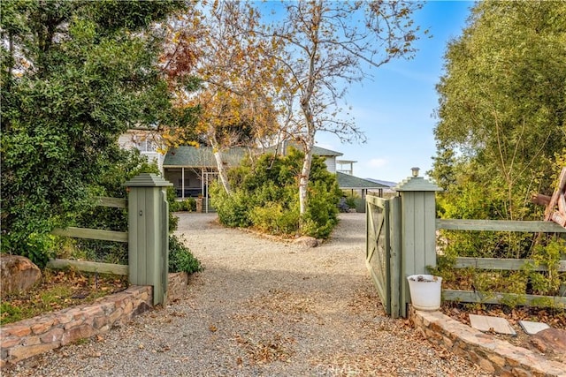 view of gate with a fenced front yard