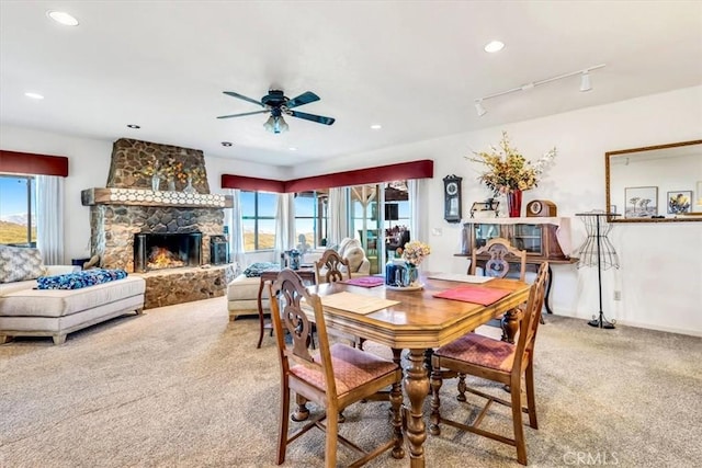 dining area featuring recessed lighting, a fireplace, rail lighting, and carpet