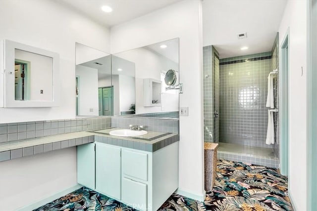 bathroom with vanity, a shower stall, and recessed lighting