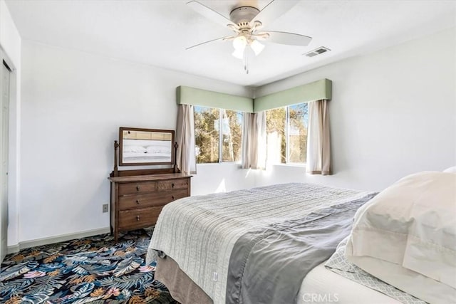 bedroom with visible vents, baseboards, and ceiling fan