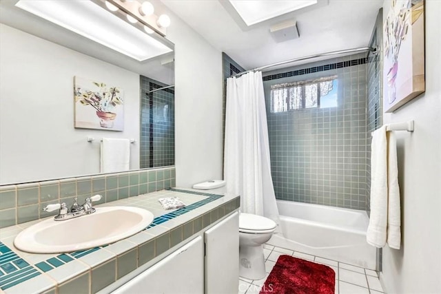 full bath with vanity, shower / bath combo, tile patterned floors, toilet, and tasteful backsplash