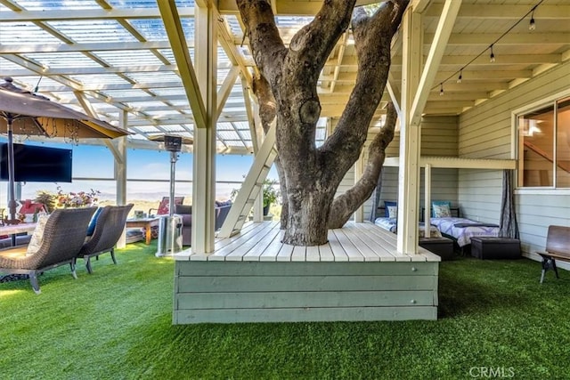 deck featuring a pergola and a yard