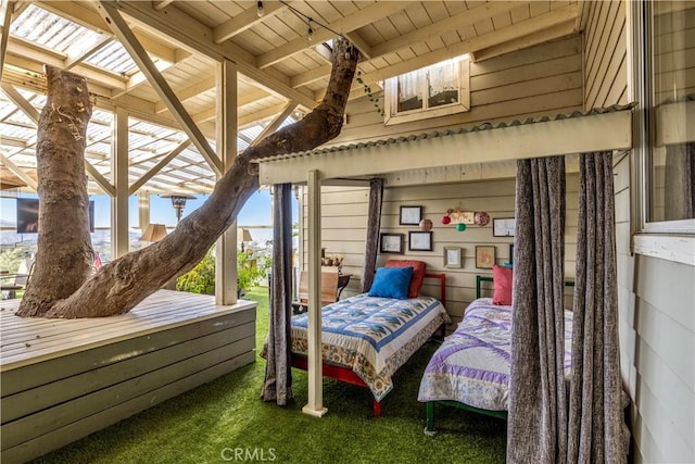 bedroom featuring wood walls, wood ceiling, lofted ceiling with beams, and carpet floors