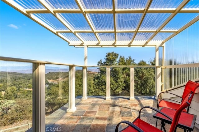 view of patio / terrace featuring a view of trees