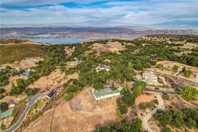 drone / aerial view with a water and mountain view