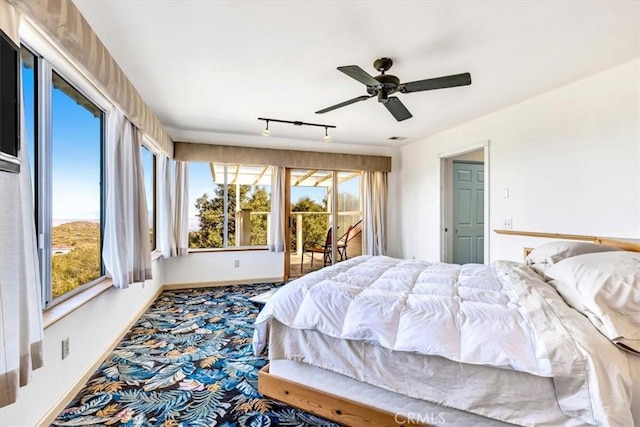 bedroom featuring visible vents, access to outside, rail lighting, baseboards, and ceiling fan