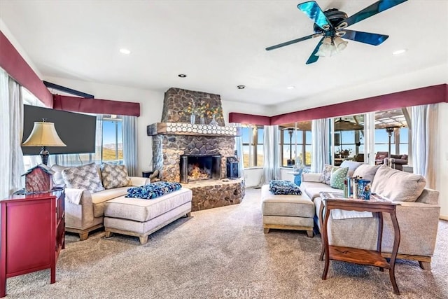 carpeted living room with a ceiling fan, recessed lighting, and a fireplace