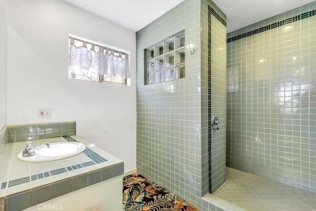 full bathroom with tiled shower