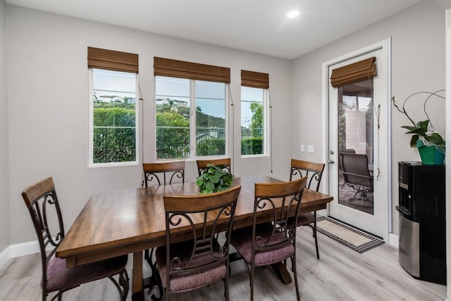 dining area featuring light wood-style flooring, recessed lighting, and baseboards