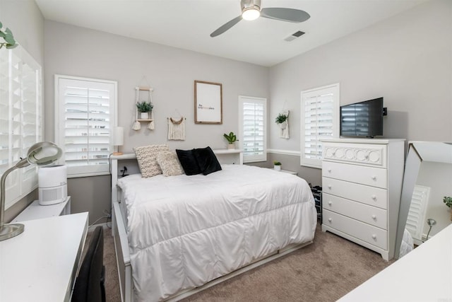 bedroom featuring visible vents, ceiling fan, and carpet