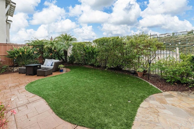 view of yard with a patio area, outdoor lounge area, and a fenced backyard