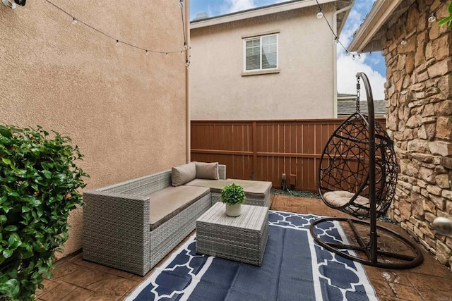 view of patio with outdoor lounge area and fence