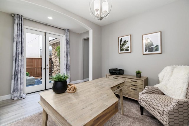 office space with french doors, baseboards, arched walkways, and wood finished floors