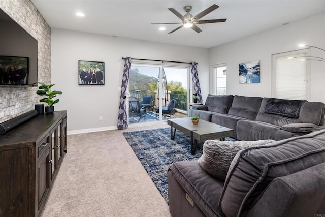 living area with recessed lighting, baseboards, light colored carpet, and a ceiling fan