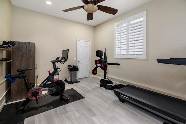 exercise room featuring a ceiling fan, baseboards, and wood finished floors