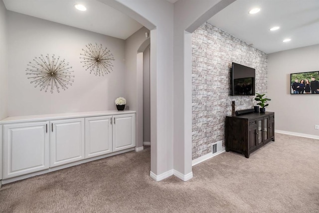 corridor with baseboards, recessed lighting, visible vents, and light carpet