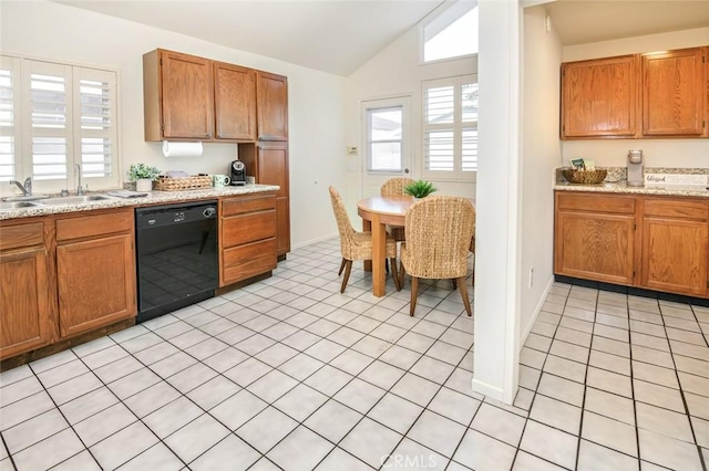 kitchen featuring a sink, brown cabinets, dishwasher, and vaulted ceiling