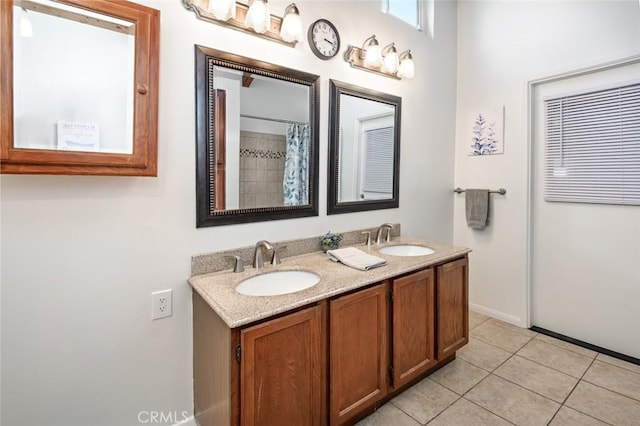 bathroom featuring tile patterned floors, double vanity, and a sink