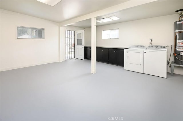 basement with water heater and washer and clothes dryer