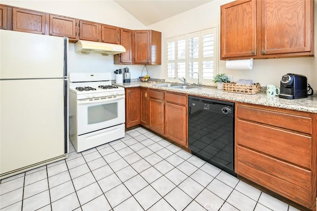 kitchen with under cabinet range hood, vaulted ceiling, brown cabinetry, white appliances, and a sink