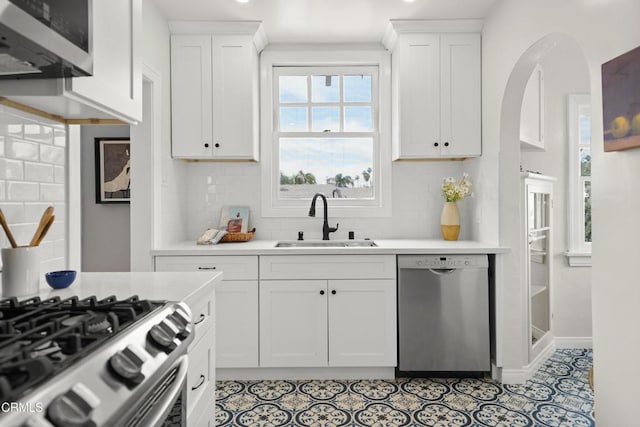 kitchen featuring a sink, white cabinetry, appliances with stainless steel finishes, and light countertops