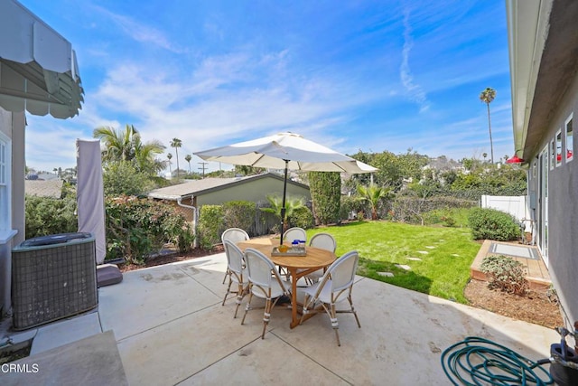 view of patio featuring outdoor dining area, cooling unit, and fence private yard