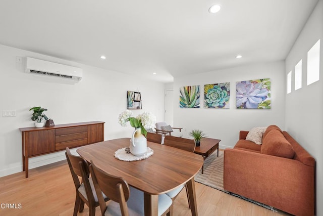 dining room with recessed lighting, light wood-style floors, and a wall unit AC