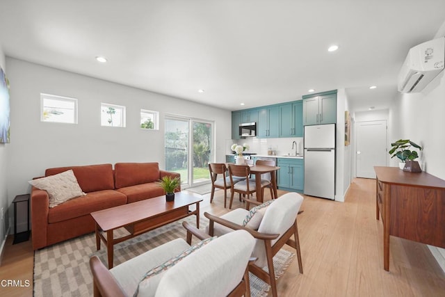 living room featuring a wall unit AC, recessed lighting, and light wood-style floors