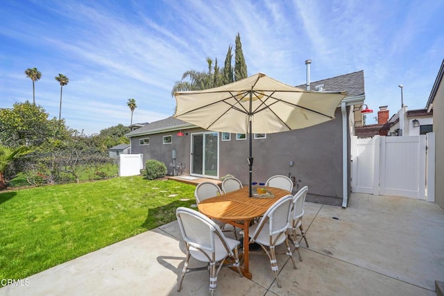 view of patio featuring fence and a gate