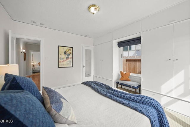 bedroom with visible vents, baseboards, and carpet