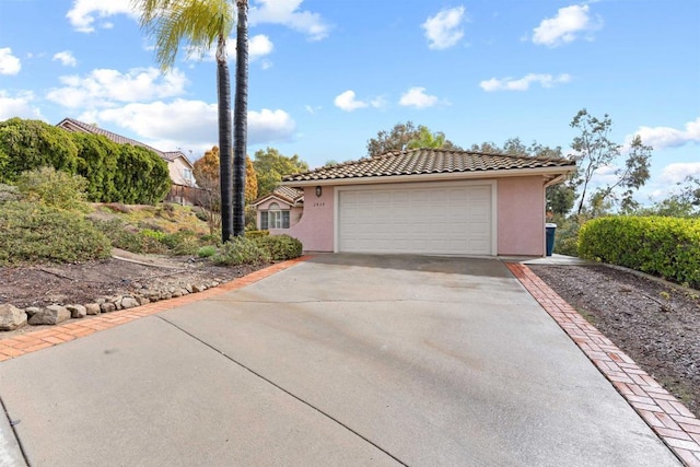 garage featuring concrete driveway