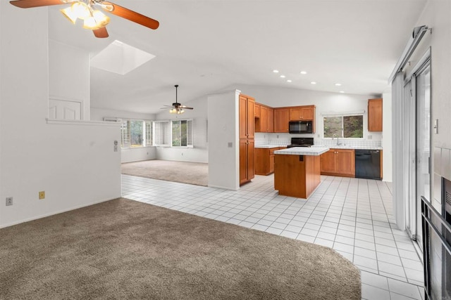 kitchen featuring black appliances, light tile patterned floors, open floor plan, and light carpet