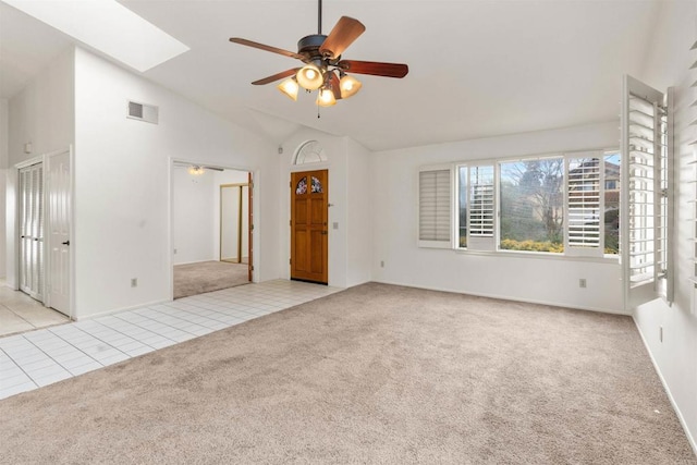 interior space featuring ceiling fan, visible vents, light colored carpet, and light tile patterned flooring