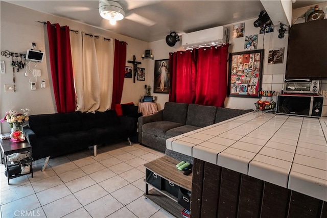 living area featuring tile patterned flooring, a toaster, a wall mounted air conditioner, and a ceiling fan