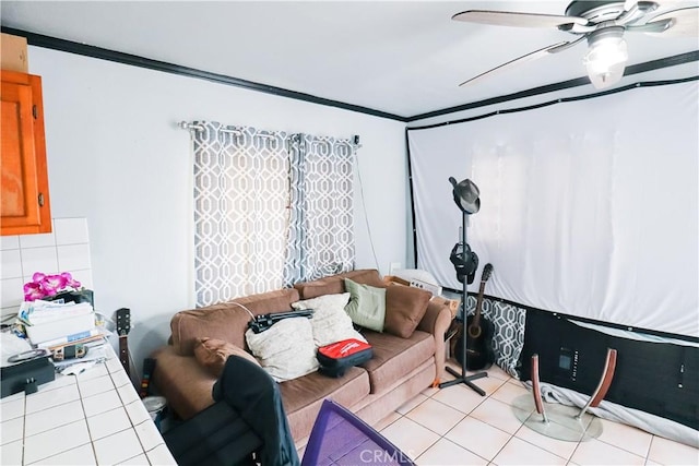 living area with light tile patterned floors, a ceiling fan, and ornamental molding