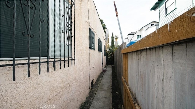 view of property exterior with fence and stucco siding