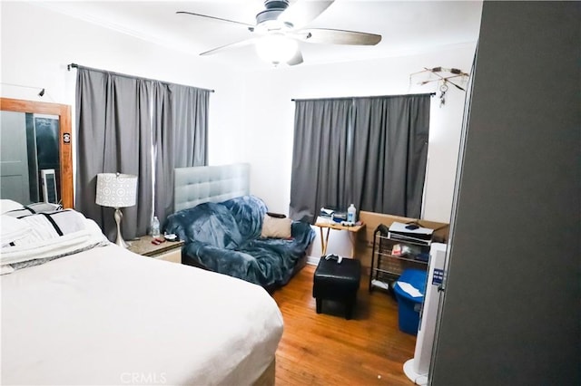 bedroom with ceiling fan and wood finished floors