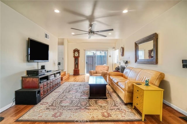 living room featuring a ceiling fan, recessed lighting, wood finished floors, and baseboards