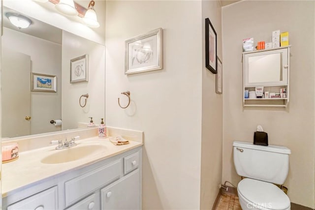 bathroom with toilet and vanity