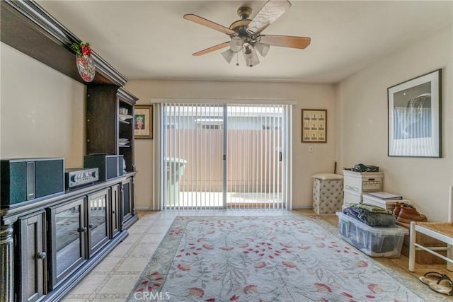 interior space with ceiling fan