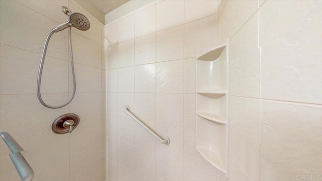 full bath featuring tiled shower