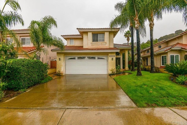 mediterranean / spanish-style home featuring driveway, stucco siding, a front lawn, a garage, and a tiled roof