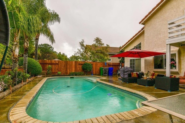 view of swimming pool featuring a patio area, an outdoor living space, a fenced in pool, and a fenced backyard