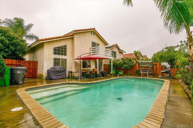 view of pool featuring a fenced in pool, a patio, area for grilling, and fence