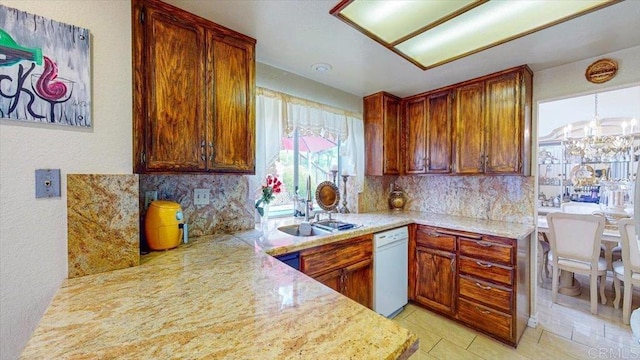 kitchen with a sink, light countertops, and white dishwasher