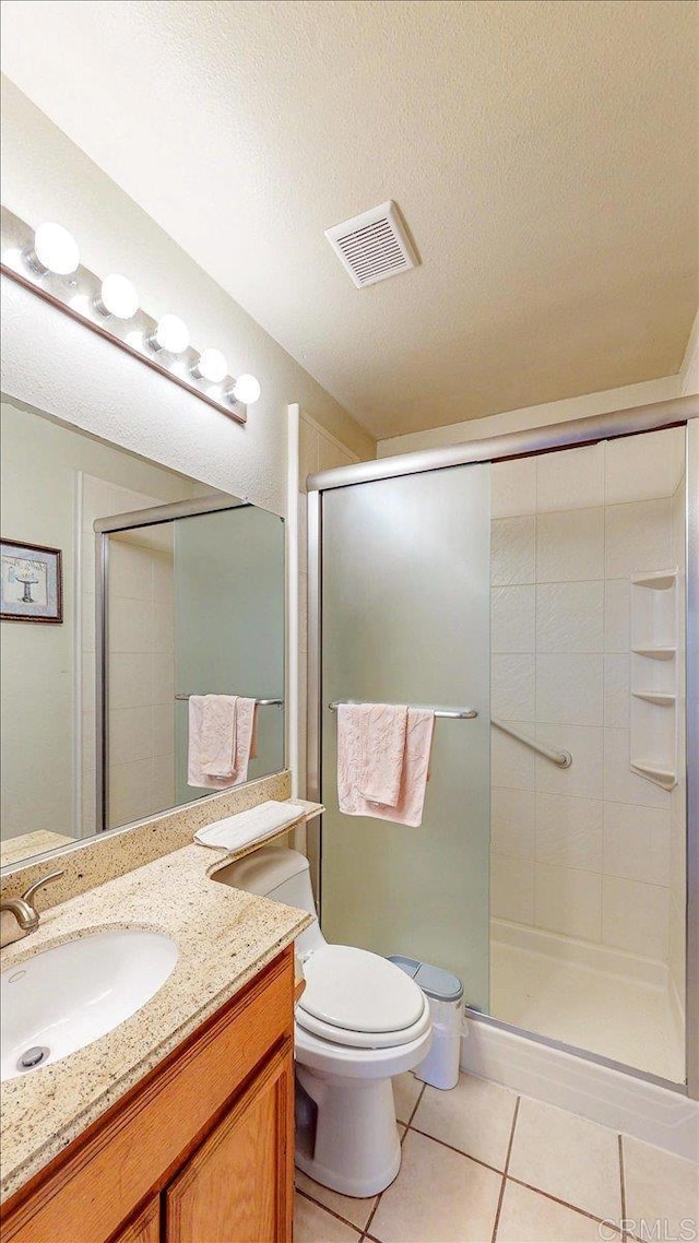 full bath with vanity, visible vents, a stall shower, tile patterned flooring, and a textured ceiling