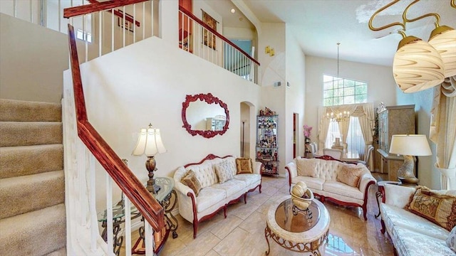 living area with arched walkways, an inviting chandelier, and stairs