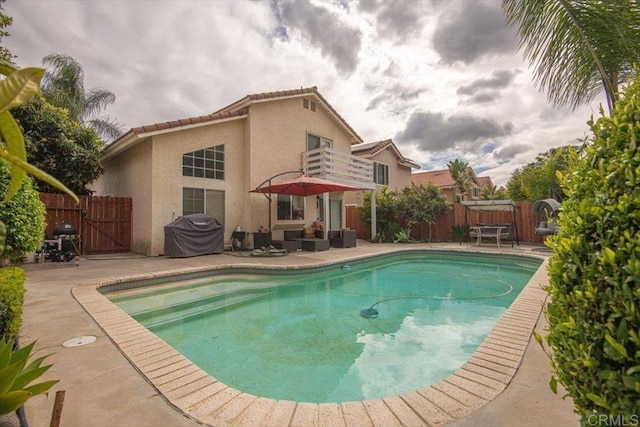 view of pool with a gate, a fenced backyard, a grill, a patio, and a fenced in pool