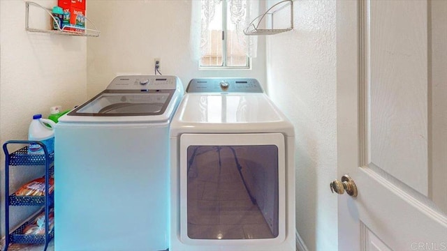 clothes washing area with separate washer and dryer and laundry area