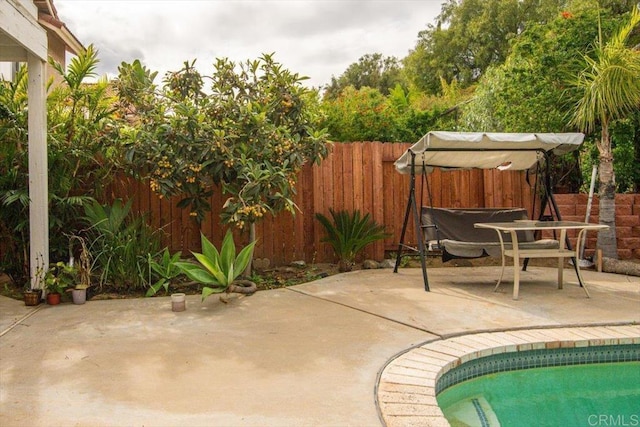 view of patio / terrace featuring fence and a fenced in pool